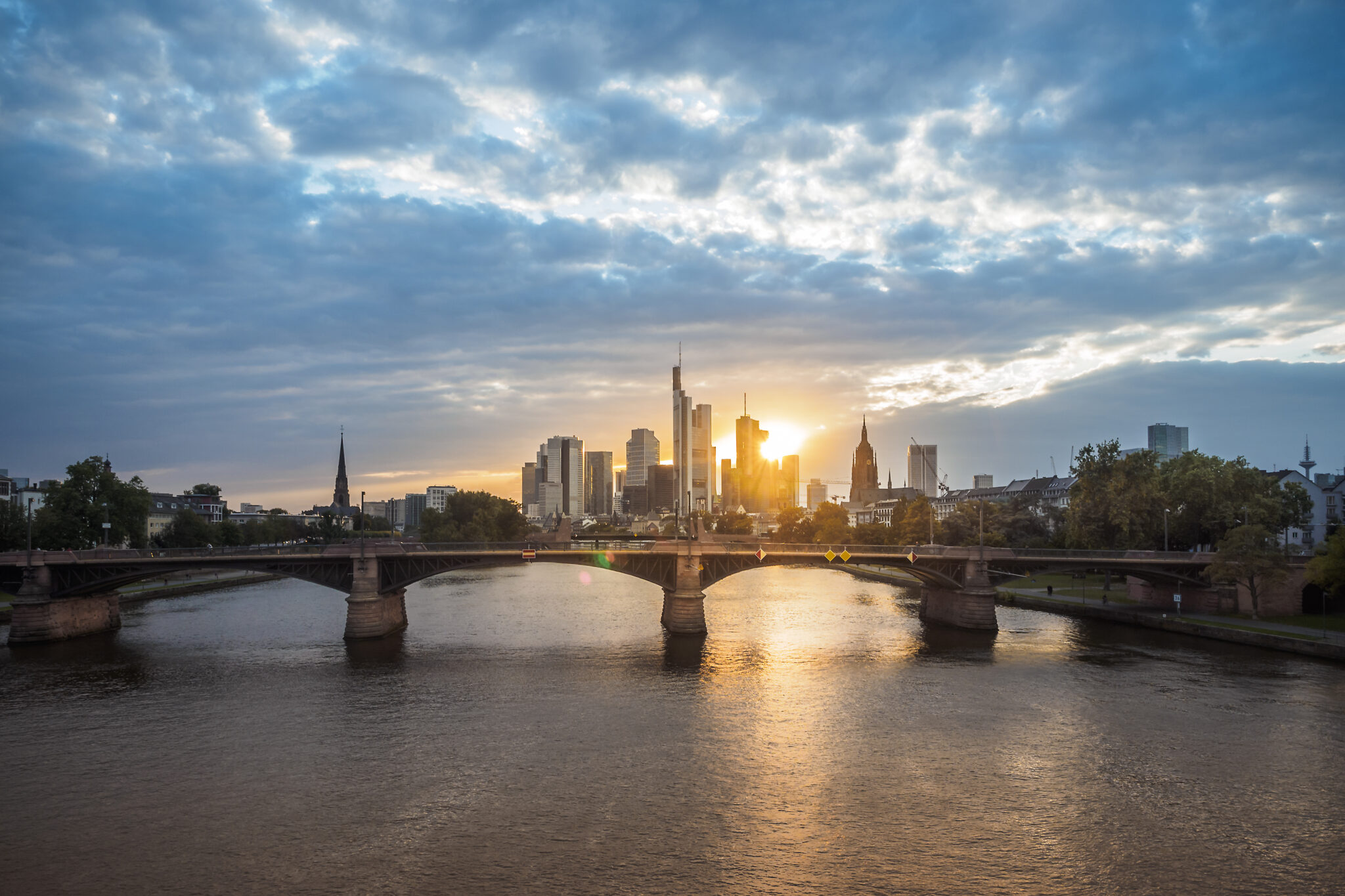Germany, Frankfurt, view to financial district at sunset with Ignatz-Bubis-Bridge in the foreground