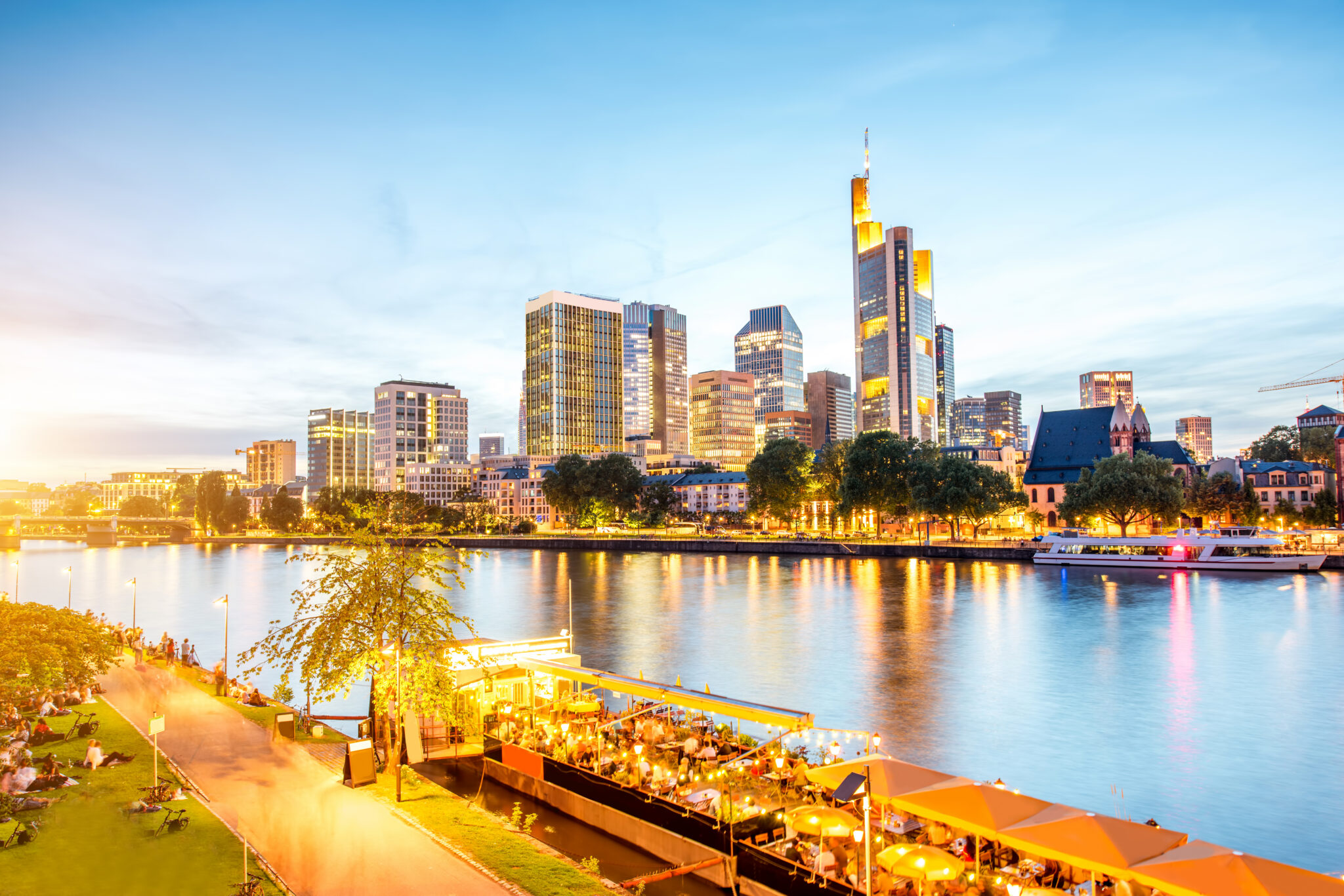 Beautiful cityscape view on the illuminated skyscrapers and bridge during the twilight in Frankfurt, Germany